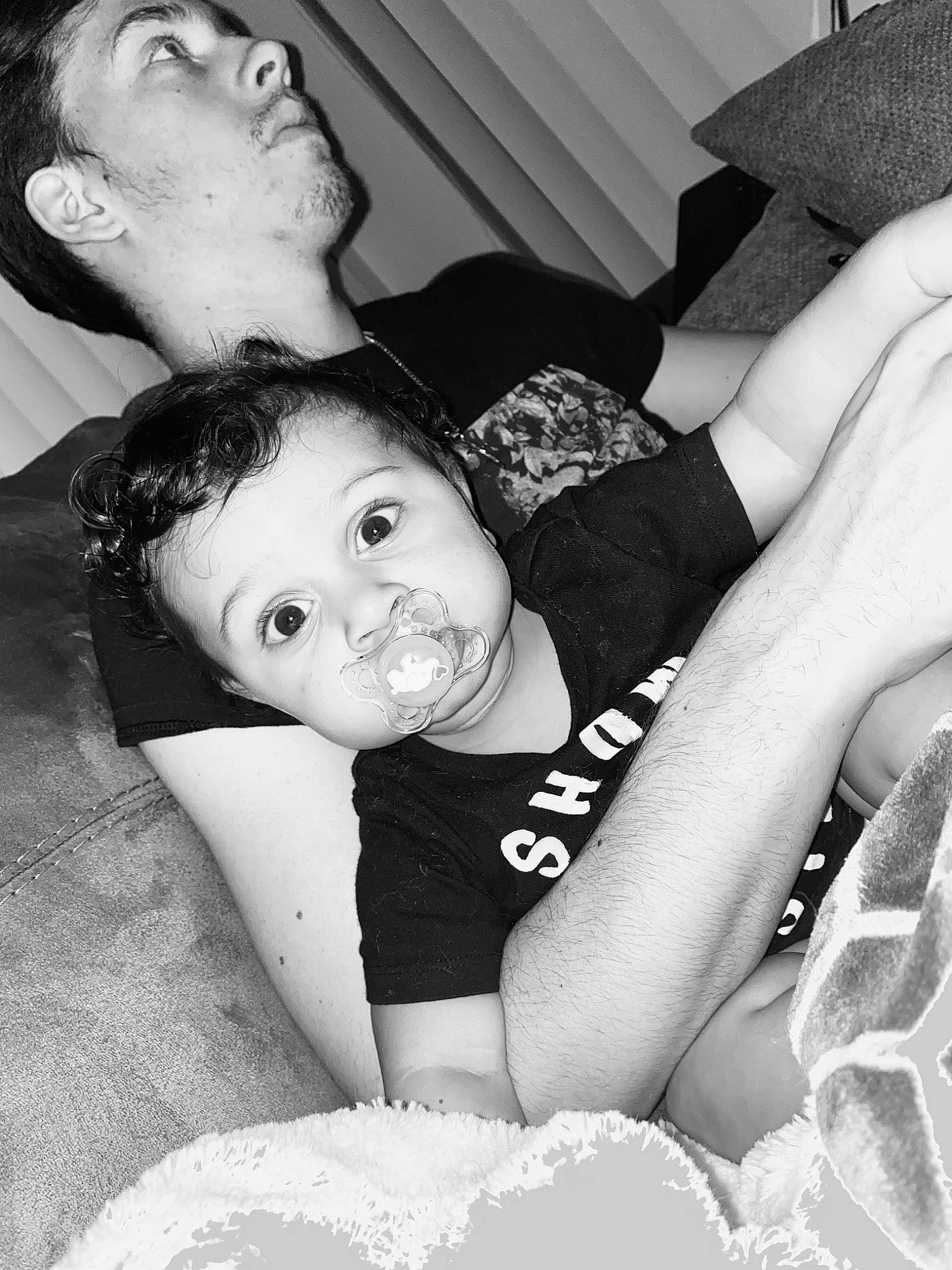 Cairo is registered to the contest to win money with this photo: arm, black, black_and_white, black_hair, comfort, elbow, eye, flash_photography, gesture, hand, happy, human, human_body, leg, organ, person, photograph, style, thigh, toddler