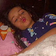 Peyton joined the competition — help win amazing prizes! child, curly_hair, pajamas, blanket, bed, pillow, cartoon, shark, fish, wall_decoration, playful, face, indoor, cozy, sleepwear, person, smiling, cute, young, fun