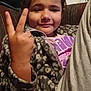 Skyler joined the competition — help win amazing prizes! brown_hair, casual_clothing, child, comfort, couch, expression, face, fleece_jacket, hand_gesture, home, indoor, peace_sign, person, portrait, relaxed, seated, sleeve, smile, young, zipper