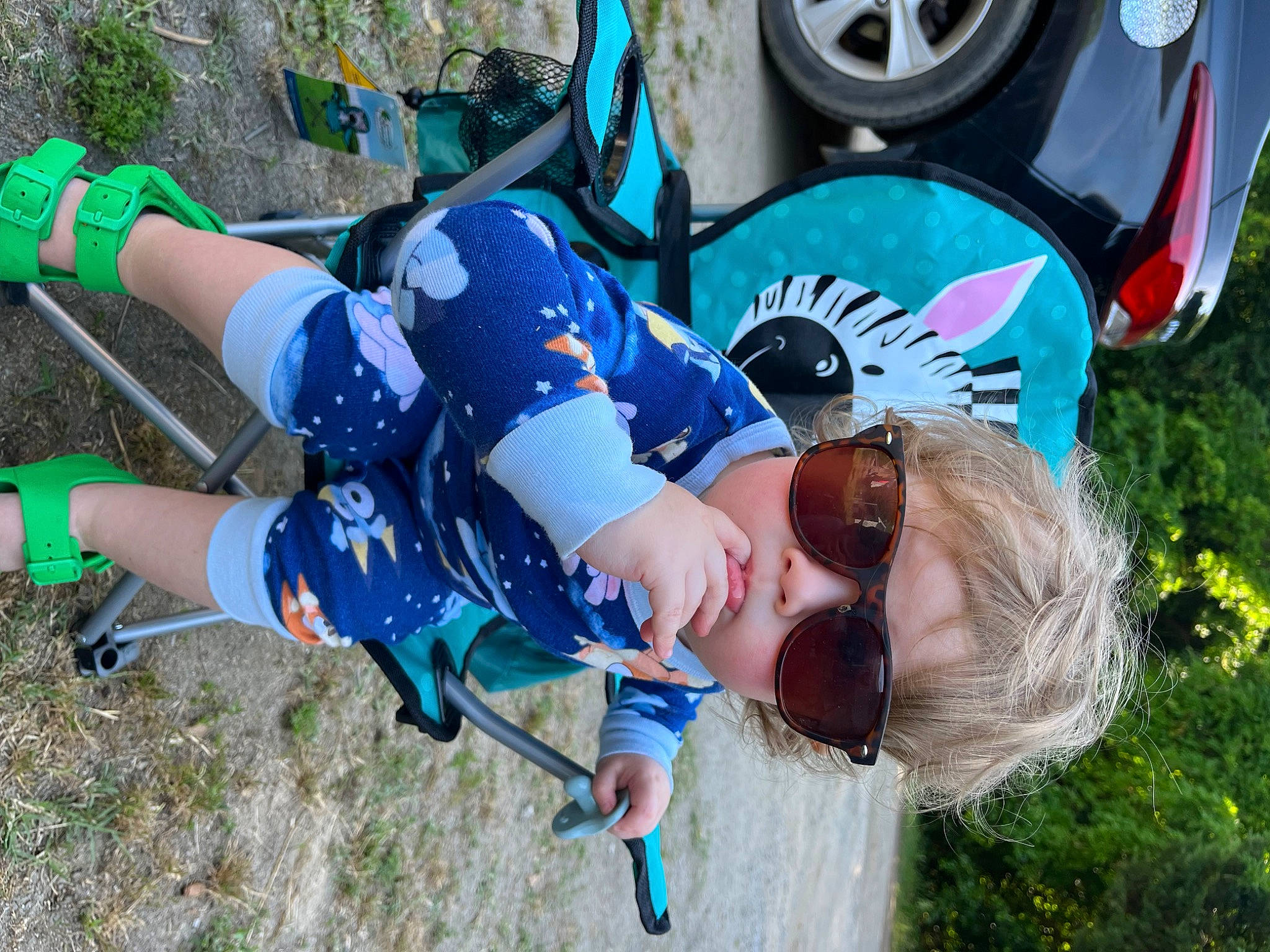 Millie joined the competition — help win amazing prizes! automotive_exterior, automotive_tire, car, cool, electric_blue, fender, grass, green, happy, hat, helmet, leisure, motor_vehicle, person, plant, shorts, sunglasses, tire, tree, vehicle