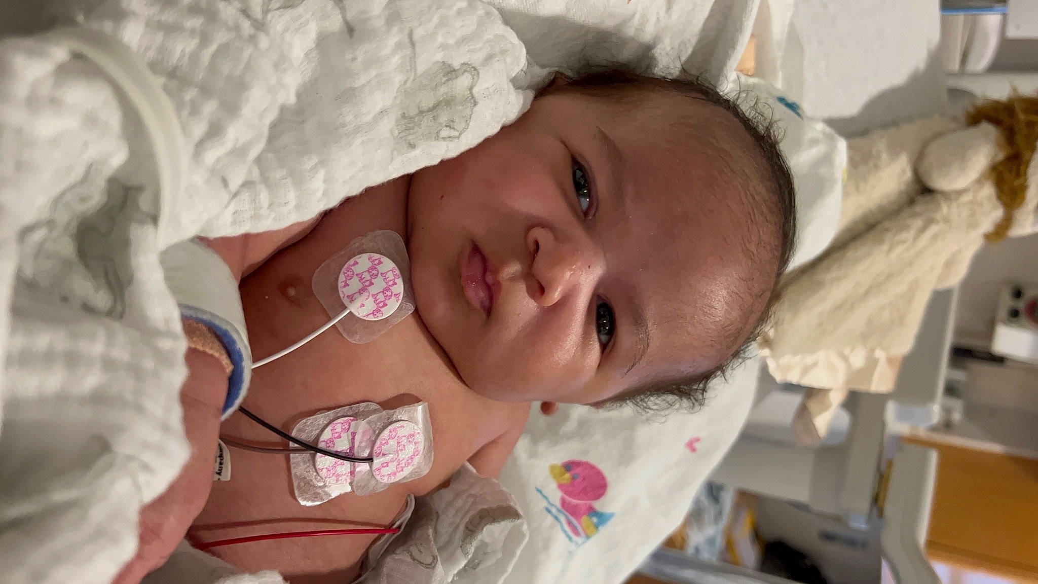 Ezra is registered to the contest to win money with this photo: baby, cheek, child, comfort, event, eye, eyebrow, eyelash, face, hand, happy, headgear, human_body, lip, mouth, neck, nose, person, skin, smile