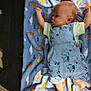 Zachariah joined the competition — help win amazing prizes! baby, blanket, overalls, dinosaur_pattern, infant, clothing, blue, light, shadow, foot, hand, face, skin, cute, lying_down, soft_texture, indoors, playful, child, person