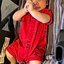 Elijah is registered to the contest to win money with this photo: baby, infant, red_clothing, romper, striped_towel, lying_down, hands, feet, face, skin, cute, child, indoors, soft_texture, comfort, expression, person, casual, relaxation, young