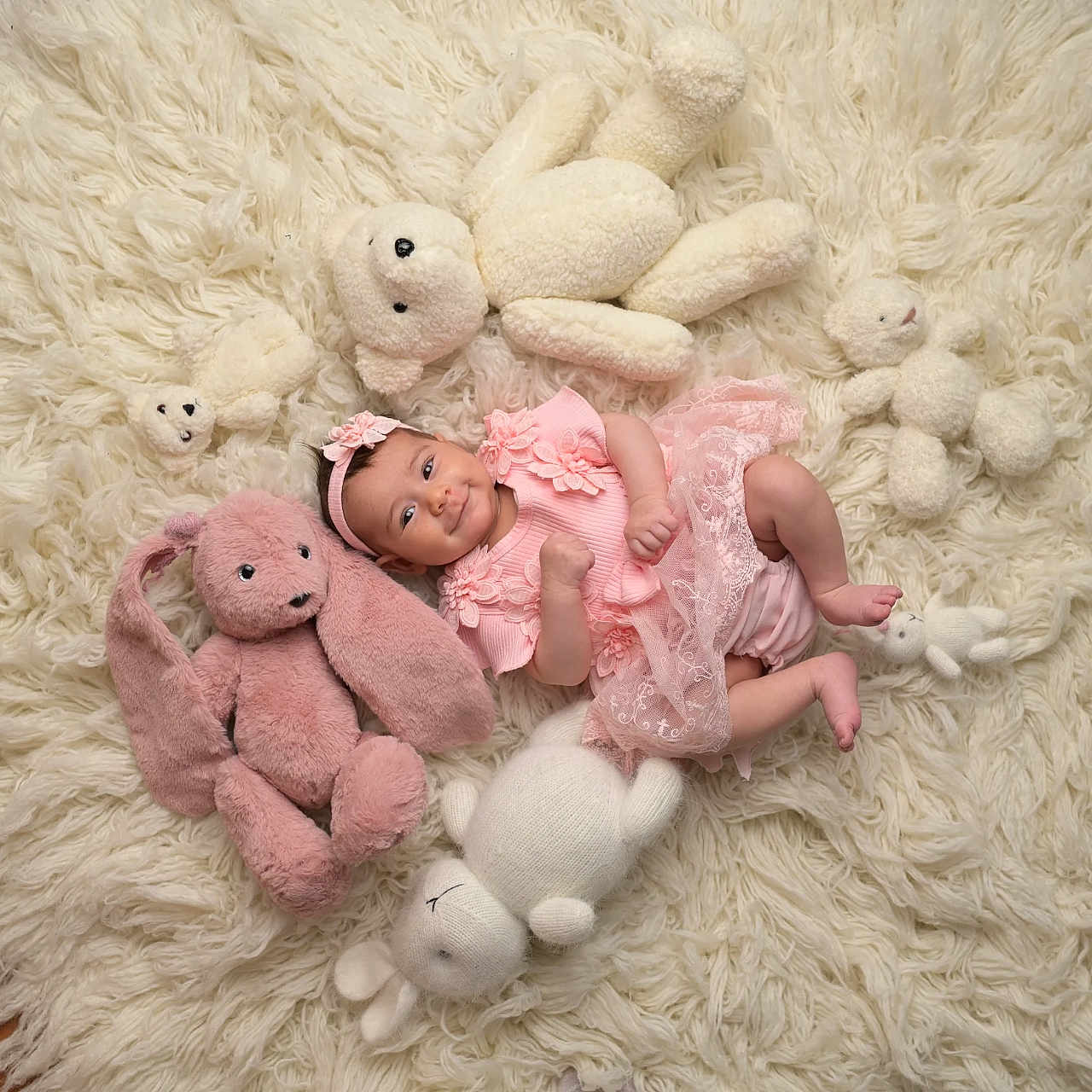 Julia a rejoint le concours — aidez-le/la à gagner de superbes lots ! baby, bunny, child, comfortable, cozy, cute, floor, happy, headband, indoors, infant, lying_down, pink_dress, playful, plush_toys, portrait, smiling, soft_texture, stuffed_animals, white_rug