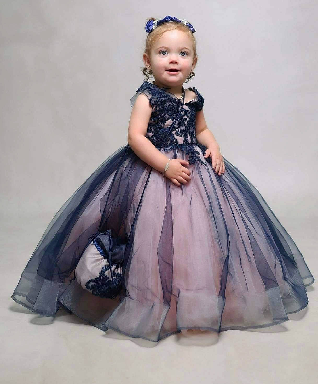 Braylon is registered to the contest to win money with this photo: arm, baby_toddler_clothing, bridal_party_dress, day_dress, dress, embellishment, eye, face, fashion_design, formal_wear, gown, hair, head, hoopskirt, one_piece_garment, person, purple, ruffle, sleeve, toy