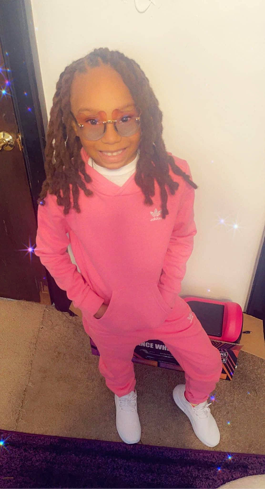 Maliyah D is registered to the contest to win money with this photo: arm, black_hair, cheek, cool, eyebrow, eyewear, finger, happy, joint, joy, lip, magenta, mouth, neck, person, pink, shoulder, skin, sleeve, smile