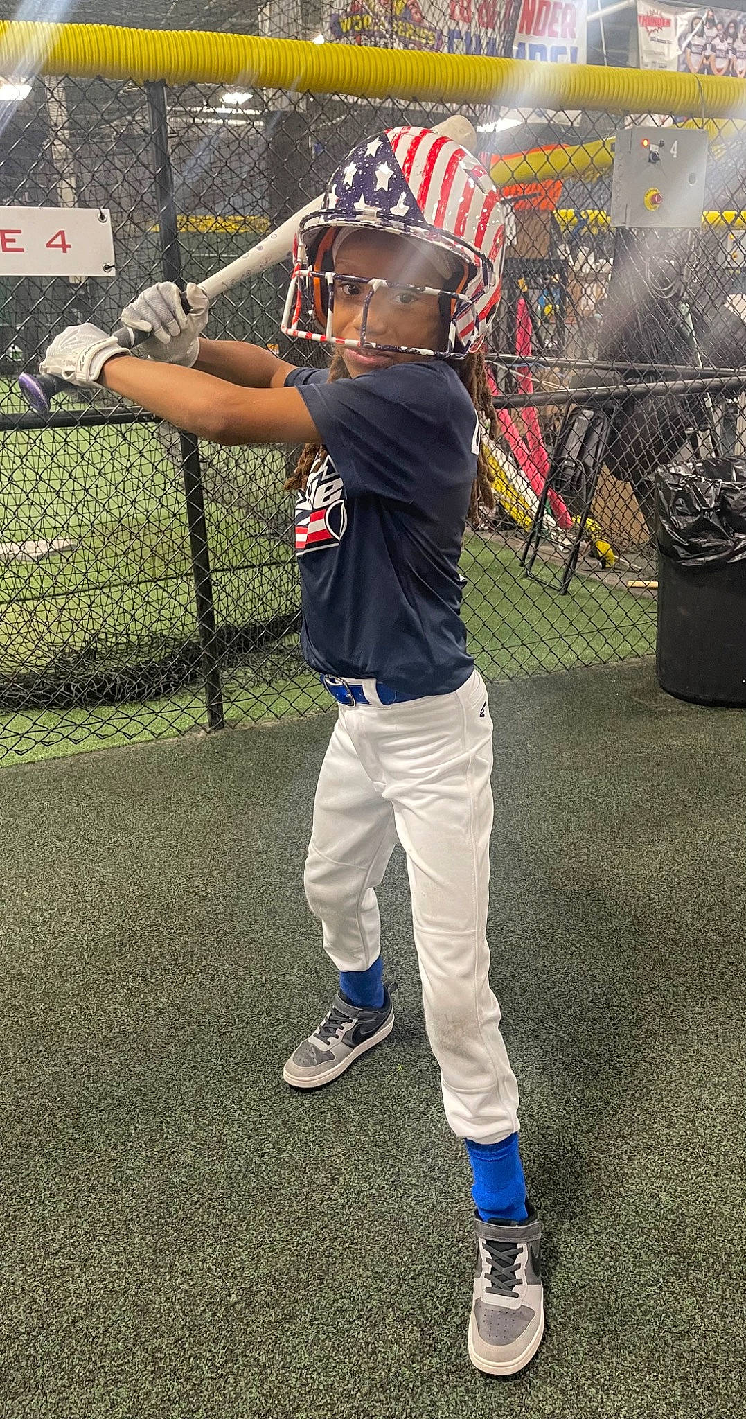 Maliyah D is registered to the contest to win money with this photo: baseball_bat, baseball_cap, baseball_equipment, baseball_player, baseball_uniform, bat_and_ball_games, cap, gesture, grass, hat, leisure, person, plant, player, shoe, sneakers, sports_gear, sports_uniform, sportswear, t_shirt