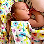 baby, newborn, sleeping, blanket, floral_pattern, infant, peaceful, soft_lighting, skin, arm, hand, closeup, indoors, resting, cute, child, person, toddler, cozy, comfort