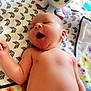 baby, infant, yawning, diaper, plush_toy, octopus, blanket, floral_pattern, cute, sleepy, lying_down, indoors, soft_light, child, newborn, skin, peaceful, comfort, toy, nap_time