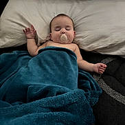 Evalynn is registered to the contest to win money with this photo: baby, sleeping, pacifier, blanket, pillow, infant, bed, rest, cozy, child, peaceful, indoor, comfort, soft, cute, relaxation, person, young, covered, nap