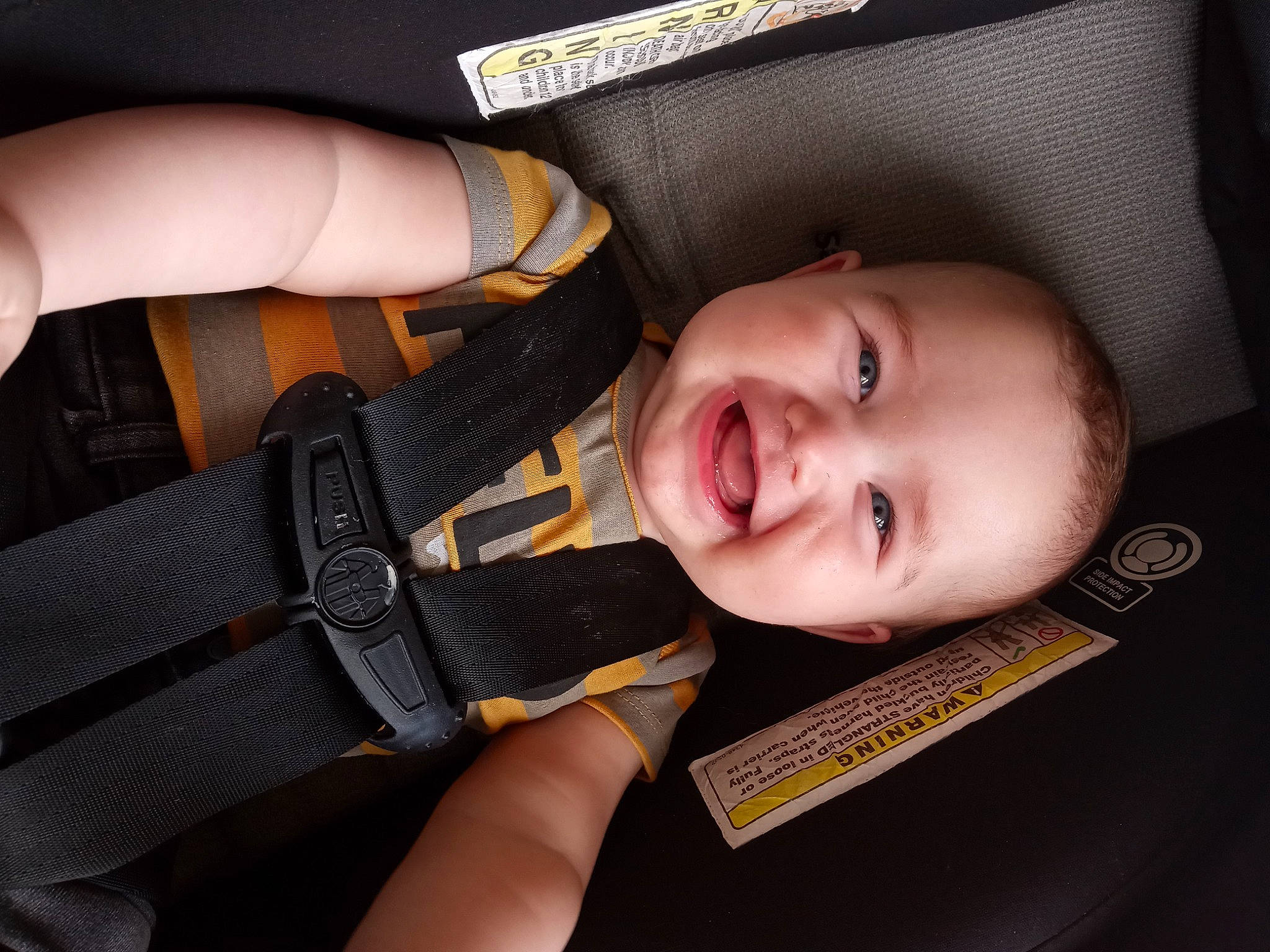 Kyler is registered to the contest to win money with this photo: baby, baby_carriage, baby_products, car_seat, cheek, child, comfort, eyelash, fashion_accessory, finger, gesture, happy, joy, nail, person, product, seat_belt, skin, smile, thumb
