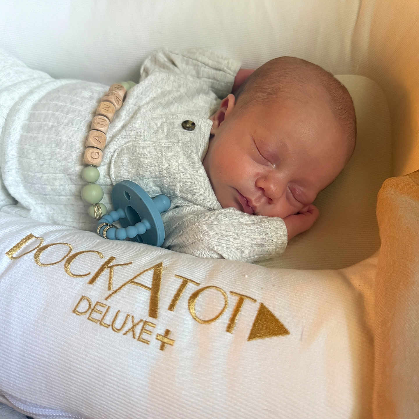 Gannan is registered to the contest to win money with this photo: baby, bed, child, closeup, clothing, cozy, cushion, cute, deluxe, dockatot, indoors, infant, newborn, pacifier, peaceful, portrait, relaxing, resting, sleeping, soft