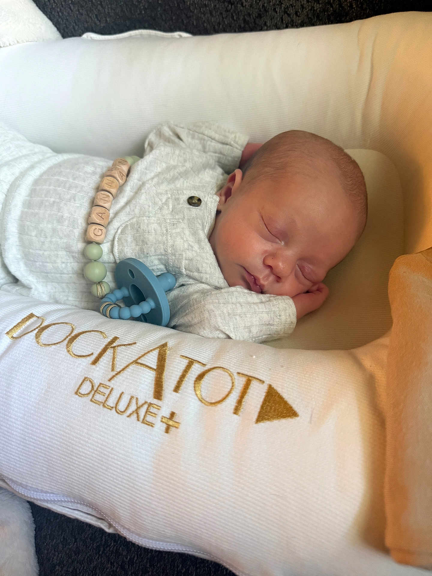Gannan is registered to the contest to win money with this photo: baby, newborn, sleeping, pacifier, dockatot, deluxe, cushion, infant, soft, cozy, resting, child, clothing, bed, closeup, peaceful, portrait, indoors, cute, relaxing