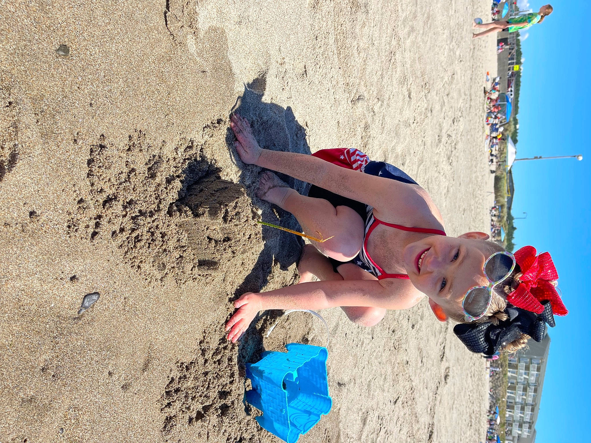 Rae-lynn Bennett joined the competition — help win amazing prizes! beach, blue, body_of_water, carmine, electric_blue, fun, happy, headwear, human_leg, joy, landscape, leisure, people_in_nature, people_on_beach, person, recreation, sand, shadow, sky, soil