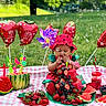 Celine is registered to the contest to win money with this photo: toddler, child, picnic, watermelon, fruit, berries, balloons, outdoor, grass, blanket, cake, hat, bubble, summer, greenery, tablecloth, snack, playful, colorful, celebration
