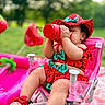 baby, chair, child, cute, drink, footwear, grass, greenery, hat, infant, outdoor, picnic, pink, playtime, red, relaxing, seat, summer, sunny, watermelon