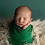 newborn, baby, sleeping, wrapped, green_cloth, blanket, fluffy, soft, portrait, peaceful, infant, cute, resting, hands, face, head, closeup, studio, calm, cozy