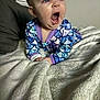 Lynette joined the competition — help win amazing prizes! baby, infant, yawning, mouth_open, blanket, bedding, pajamas, patterned_clothing, eyes, cheeks, hands, bed, indoor, portrait, close_up, expression, crawling_position, soft_texture, cute, playful