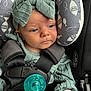 baby, baby_clothes, calm, car_seat, child, child_safety, cushion, cute, fish_pattern, green_clothing, headband, indoors, infant, knitwear, pacifier, portrait, safety_harness, seatbelt, small_hands, young_child