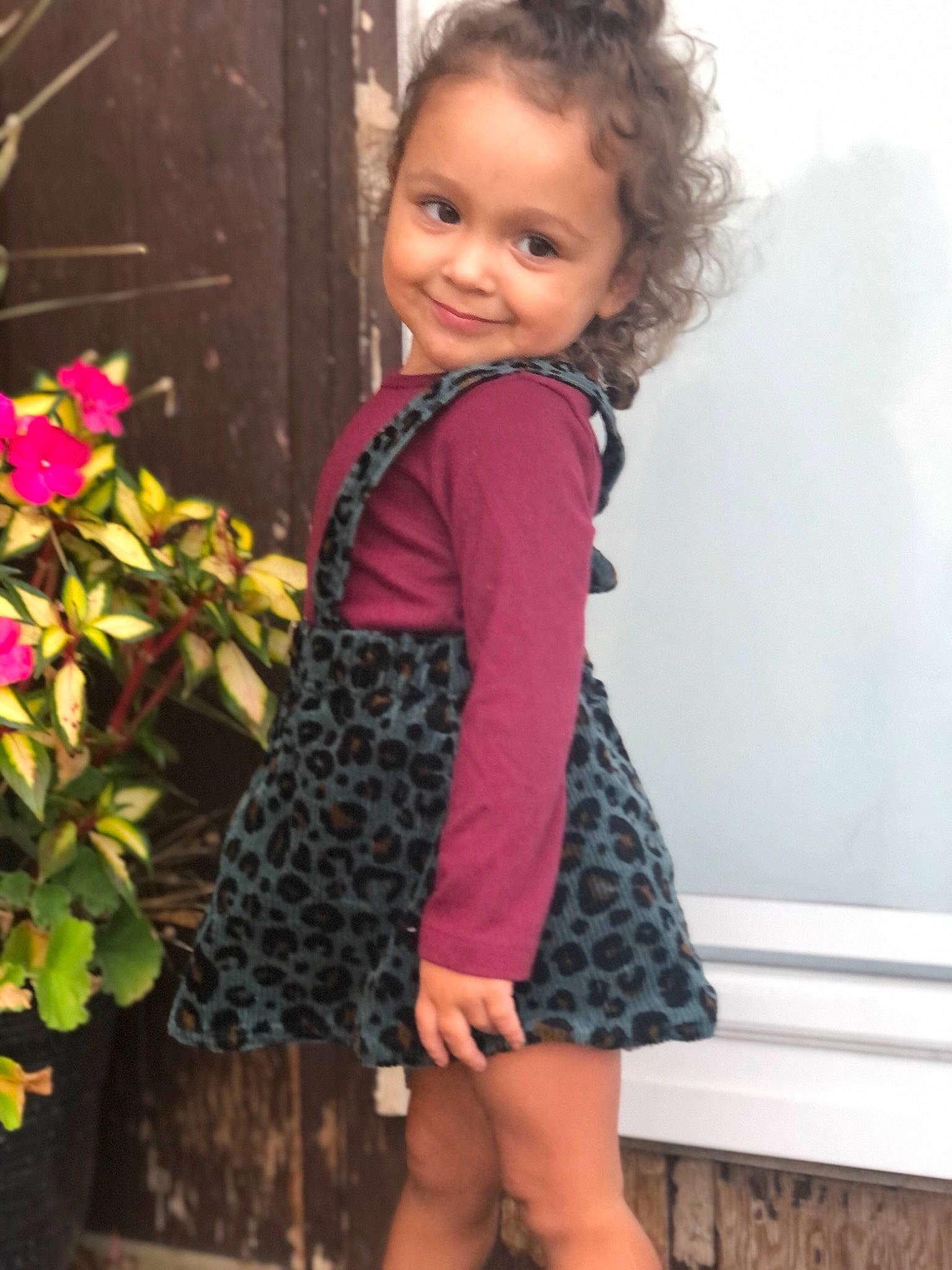 Aliza is registered to the contest to win money with this photo: annual_plant, baby, baby_toddler_clothing, child, child_model, day_dress, happy, herbaceous_plant, joy, laugh, magenta, one_piece_garment, pattern, pedicel, person, petal, pink, ringlet, shrub, sleeve