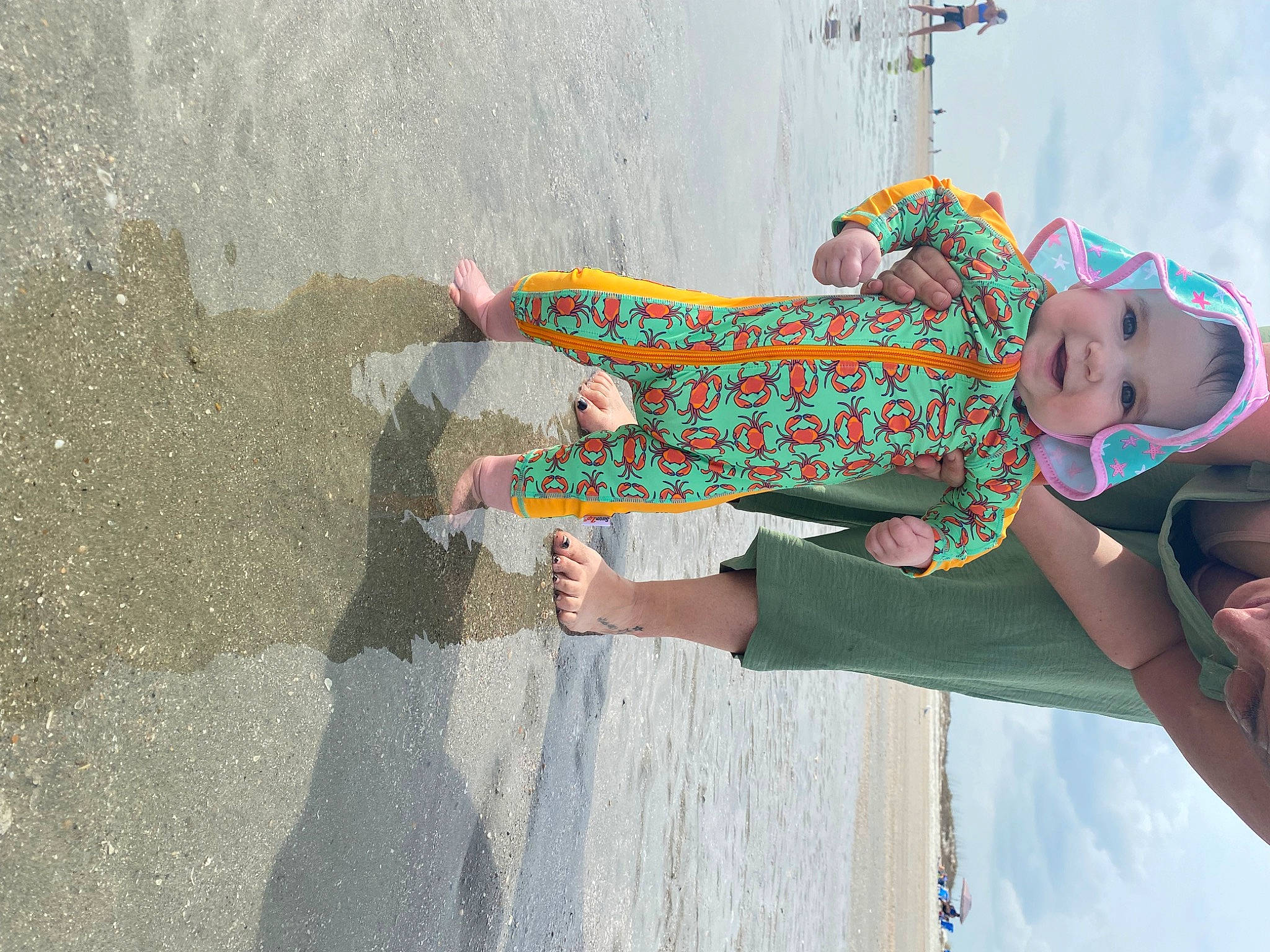 Calliope is registered to the contest to win money with this photo: asphalt, beach, child, concrete, foot, fun, happy, headwear, human_leg, leisure, pattern, person, recreation, road_surface, shadow, sidewalk, sitting, sky, thigh, travel