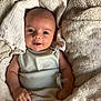 baby, bed, blanket, child, comfort, cozy, cute, fabric, face, happy, indoors, infant, pacifier, person, sleepwear, smile, soft, texture, warm, wrapped