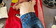Aaron participe au concours pour gagner de l'argent avec cette photo : baby, baby_essentials, cactus, casual, clothing, diaper, footwear, indoor, infant, jeans, keys, newborn, pacifier, person, plant, relaxed, shirt, table, towel, wooden_surface