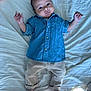Joud participe au concours pour gagner de l'argent avec cette photo : baby, infant, denim_shirt, beige_pants, bed, white_bedspread, barefoot, curious_expression, lying_down, indoors, child, person, clothing, casual_wear, small_hands, small_feet, portrait, relaxing, cute, young