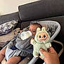 Joud a rejoint le concours — aidez-le/la à gagner de superbes lots ! baby, bottle, toy, hand, baby_seat, sofa, pillow, milk, infant, indoors, person, couch, clothing, cute, plush, smile, face, relaxing, comfort, child