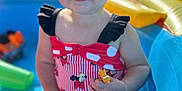 Sadie joined the competition — help win amazing prizes! toddler, child, smiling, inflatable_pool, toy, water, summer, outdoor, sunlight, play, baby, sitting, cute, red_swimsuit, black_ruffles, happy, skin, foot, arm, face