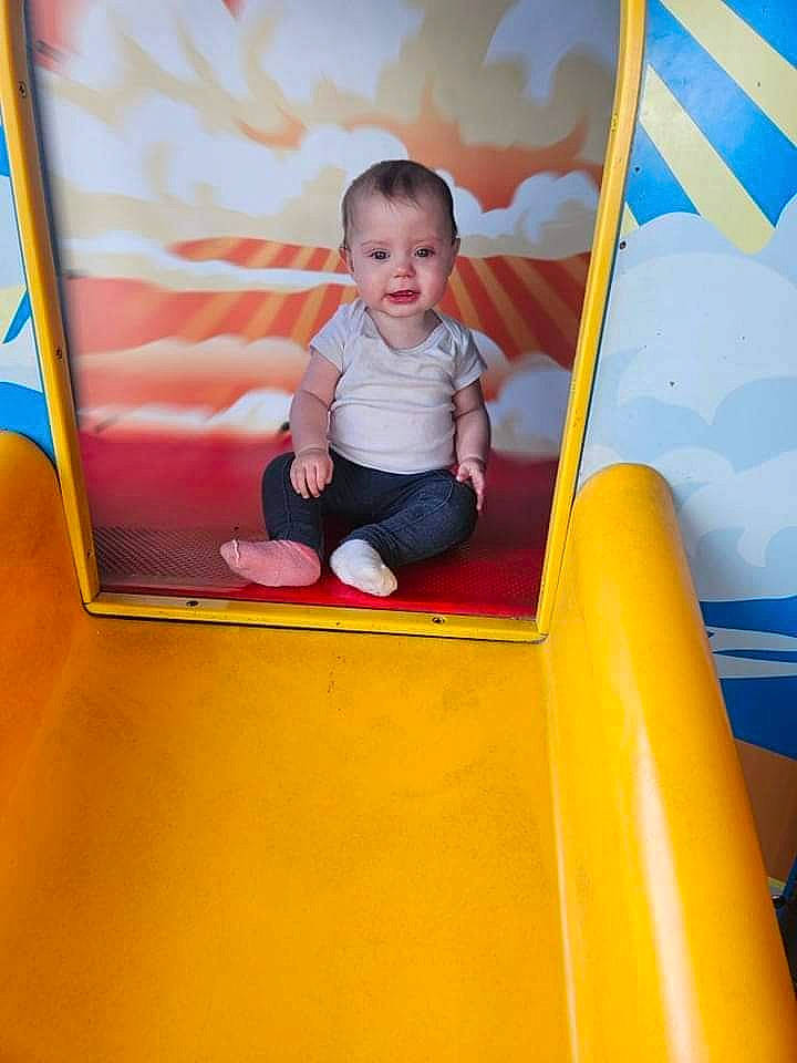 Lainey joined the competition — help win amazing prizes! baby, baby_toddler_clothing, child, chute, city, fun, leisure, magenta, outdoor_play_equipment, person, play, playground, playground_slide, recreation, room, sitting, smile, t_shirt, toddler