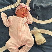 Harper joined the competition — help win amazing prizes! baby, newborn, sleeping, pink_clothing, headband, milk_bottle, blanket, bed, infant, peaceful, cute, soft, indoors, rest, child, portrait, cozy, toddler, lying_down, comfort