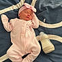 baby, newborn, sleeping, pink_clothing, headband, milk_bottle, blanket, bed, infant, peaceful, cute, soft, indoors, rest, child, portrait, cozy, toddler, lying_down, comfort