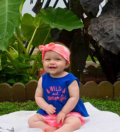 Lyra joined the competition — help win amazing prizes! baby, baby_toddler_clothing, botany, cap, child, electric_blue, foot, fun, grass, happy, hat, headgear, headwear, joy, lap, leisure, person, plant, sitting, smile