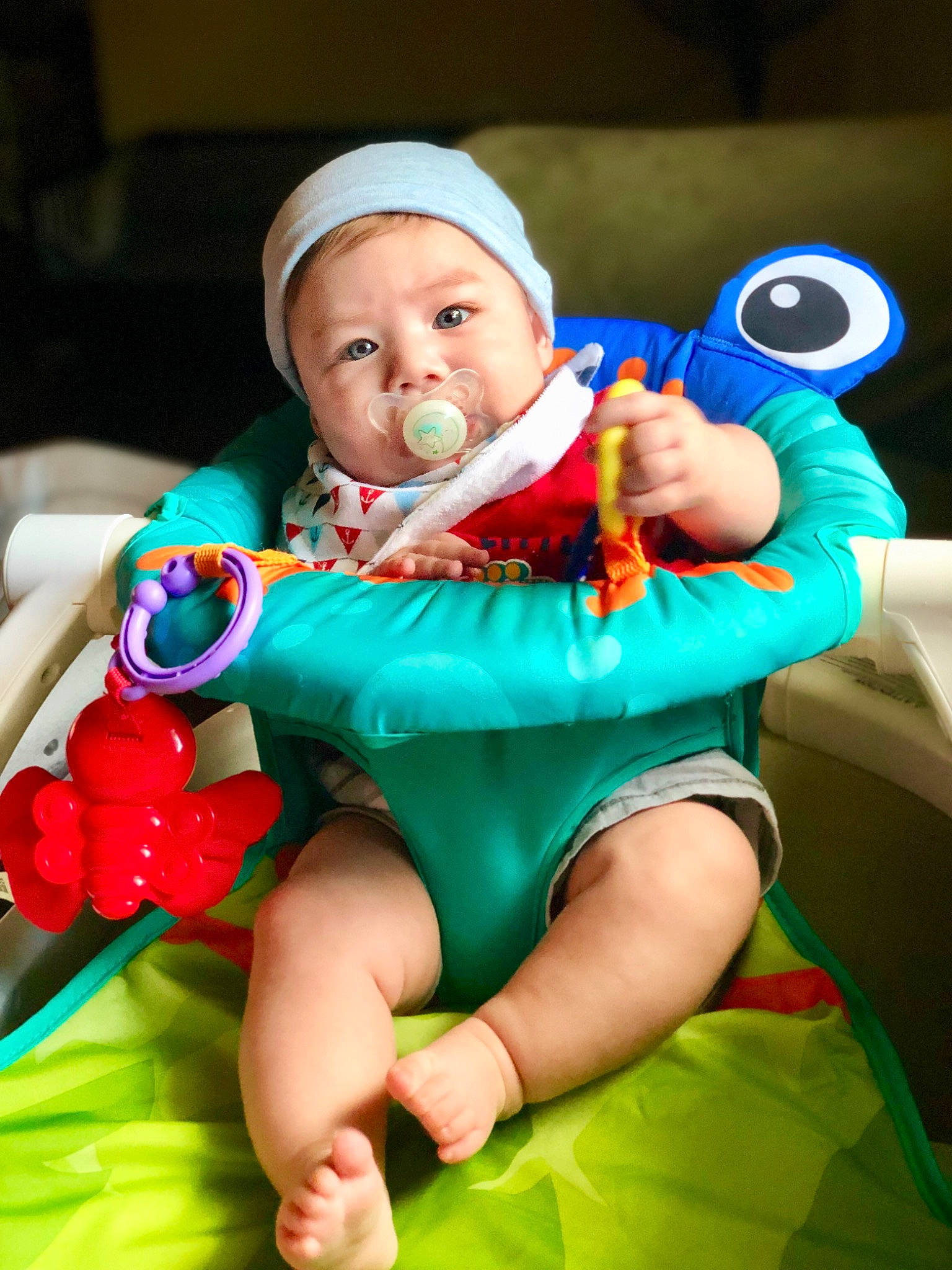 Calel is registered to the contest to win money with this photo: arm, baby, baby_products, baby_toys, child, eye, fictional_character, fun, green, leg, person, play, product, sitting, skin, smile, toddler, toy