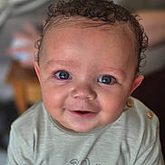 Cole joined the competition — help win amazing prizes! baby, child, smiling, face, curly_hair, eyes, shirt, clothing, infant, portrait, cute, happy, button, toddler, young_child, skin, person, indoors, closeup, expression