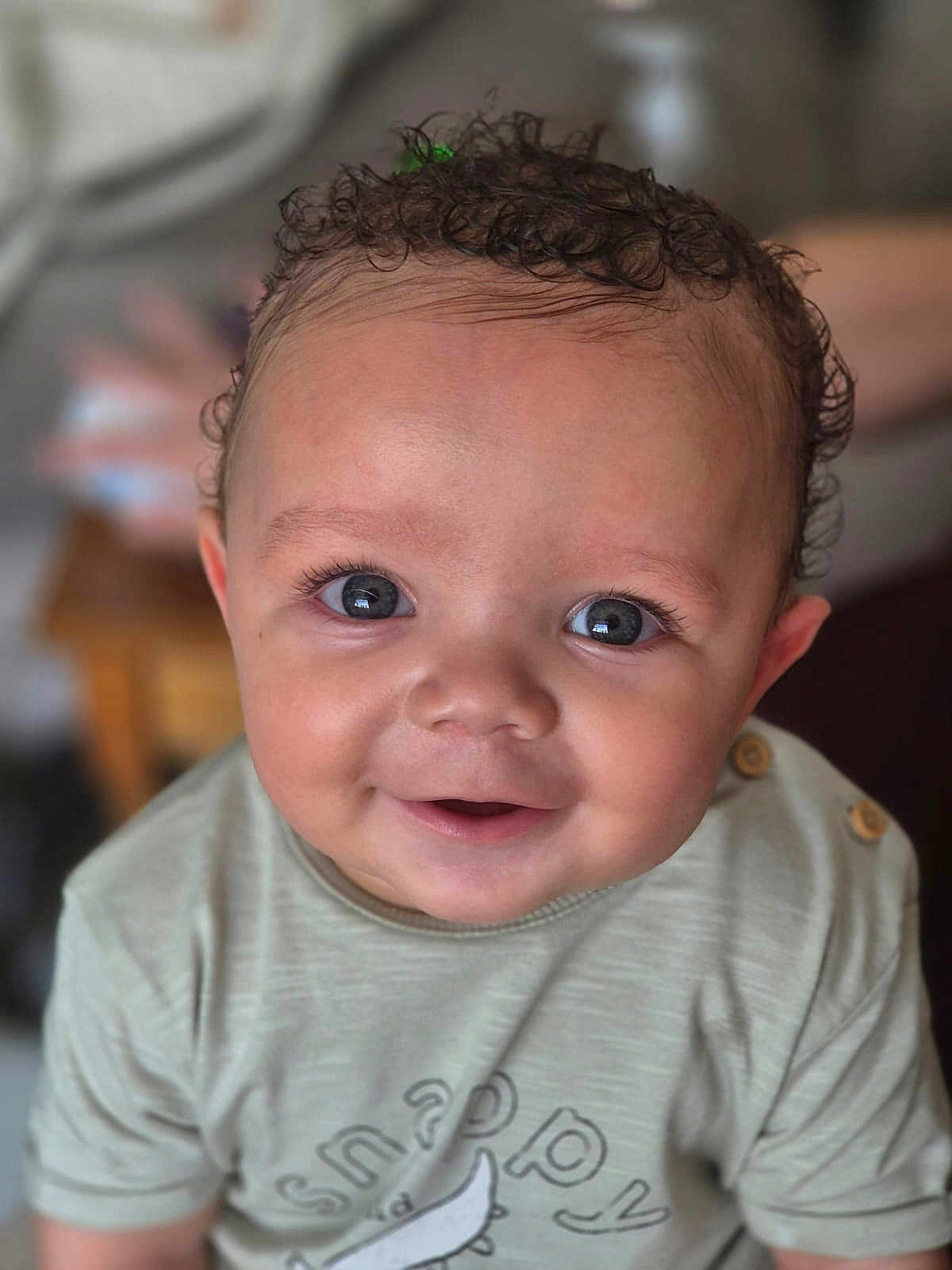 Cole joined the competition — help win amazing prizes! baby, child, smiling, face, curly_hair, eyes, shirt, clothing, infant, portrait, cute, happy, button, toddler, young_child, skin, person, indoors, closeup, expression
