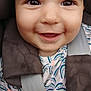 baby, child, smile, face, eyes, car_seat, seatbelt, clothing, pattern, infant, closeup, happy, cute, skin, mouth, tongue, shoulder, fabric, protection, young