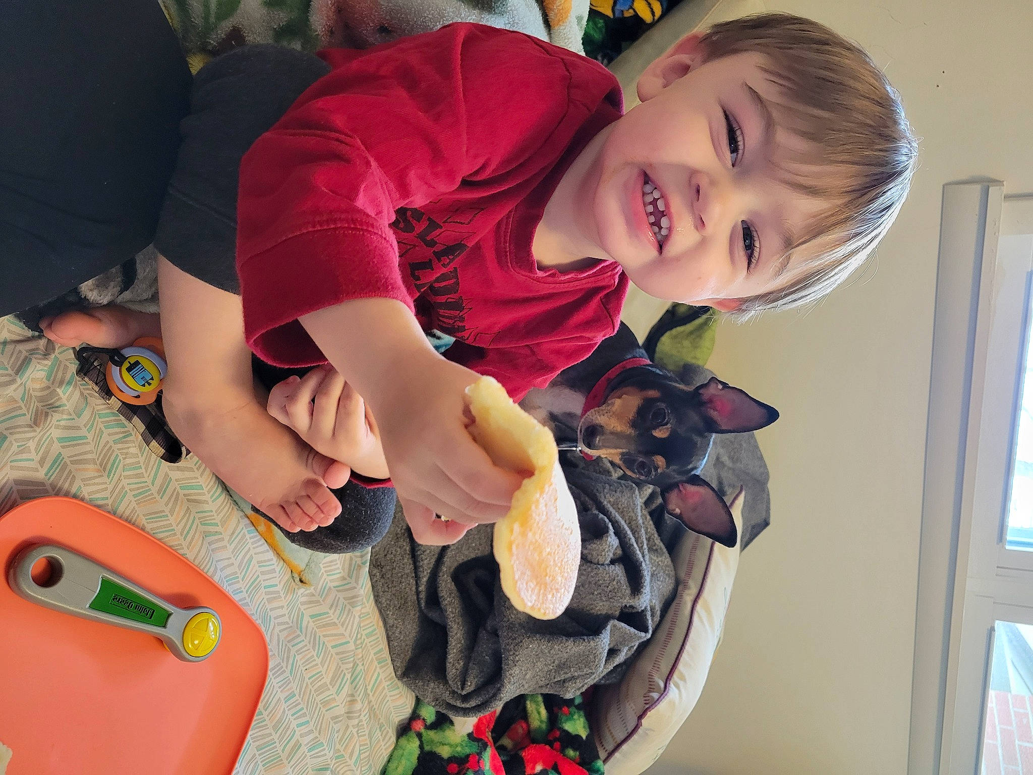 Colson is registered to the contest to win money with this photo: baby, baby_products, baby_toddler_clothing, baby_toys, child, finger, fun, happy, lap, person, play, recreation, room, sitting, smile, stuffed_toy, t_shirt, thigh, toddler, toy