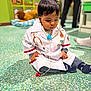 Lewis participe au concours pour gagner de l'argent avec cette photo : child, toddler, baby, doctor_costume, stethoscope, sitting, indoor, playroom, toy, plush_lion, colorful, floor, portrait, clothing, socks, hair, curiosity, cute, kid, playing