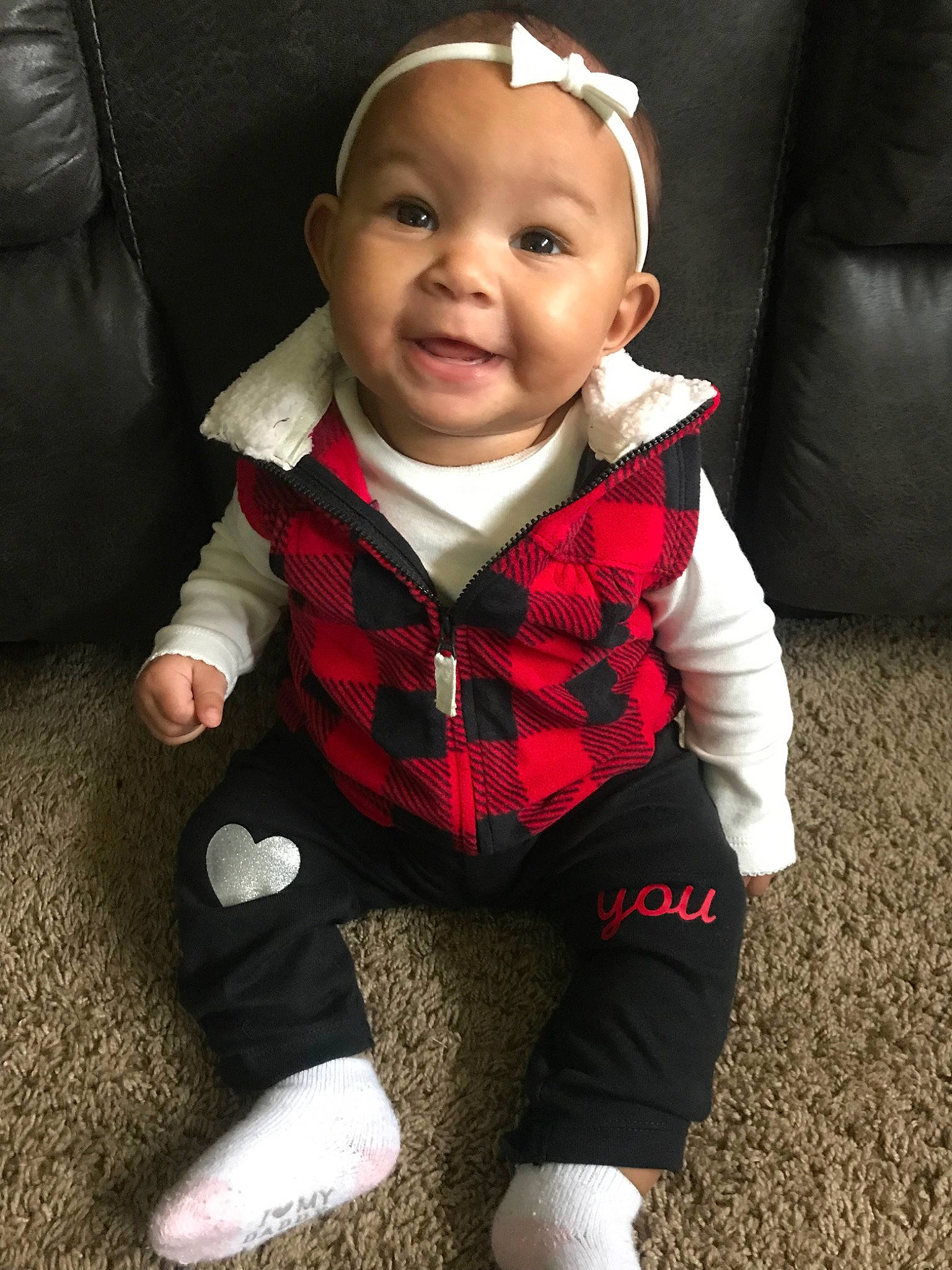 Lyanna is registered to the contest to win money with this photo: baby, cheek, child, child_model, cool, design, face, facial_expression, head, lip, outerwear, pattern, person, sitting, skin, smile, standing, toddler