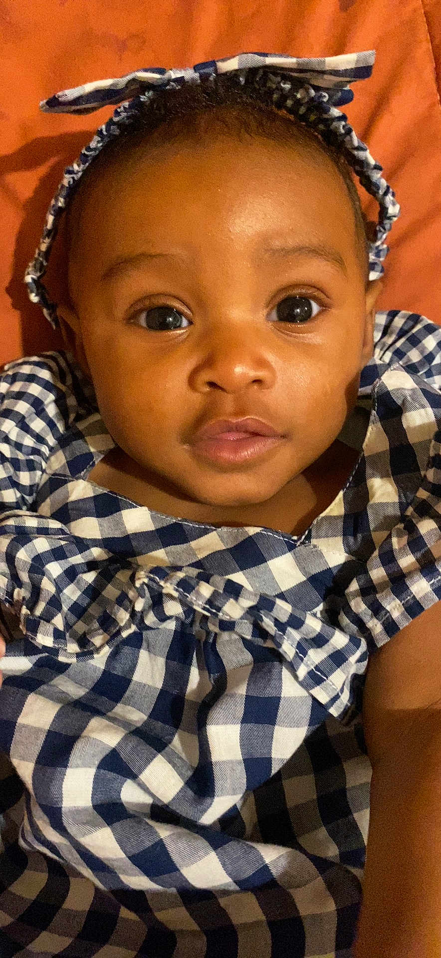 Gerzi joined the competition — help win amazing prizes! baby, child, face, eyes, headband, dress, blue, white, checkered, pattern, clothing, portrait, infant, cute, skin, expression, young, person, lying, background