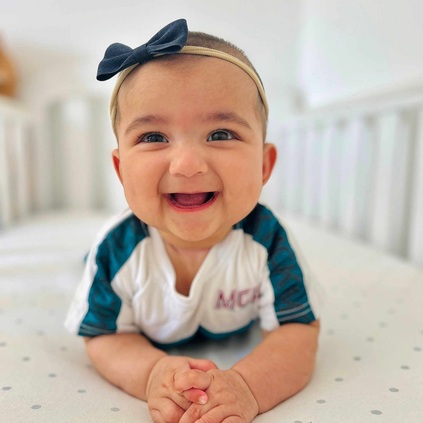 Ayzel joined the competition — help win amazing prizes! baby, bow, child, closeup, clothing, cute, hands, happy, headband, indoors, infant, lying_down, mattress, nursery, person, polka_dot, portrait, smiling, soft_light, young