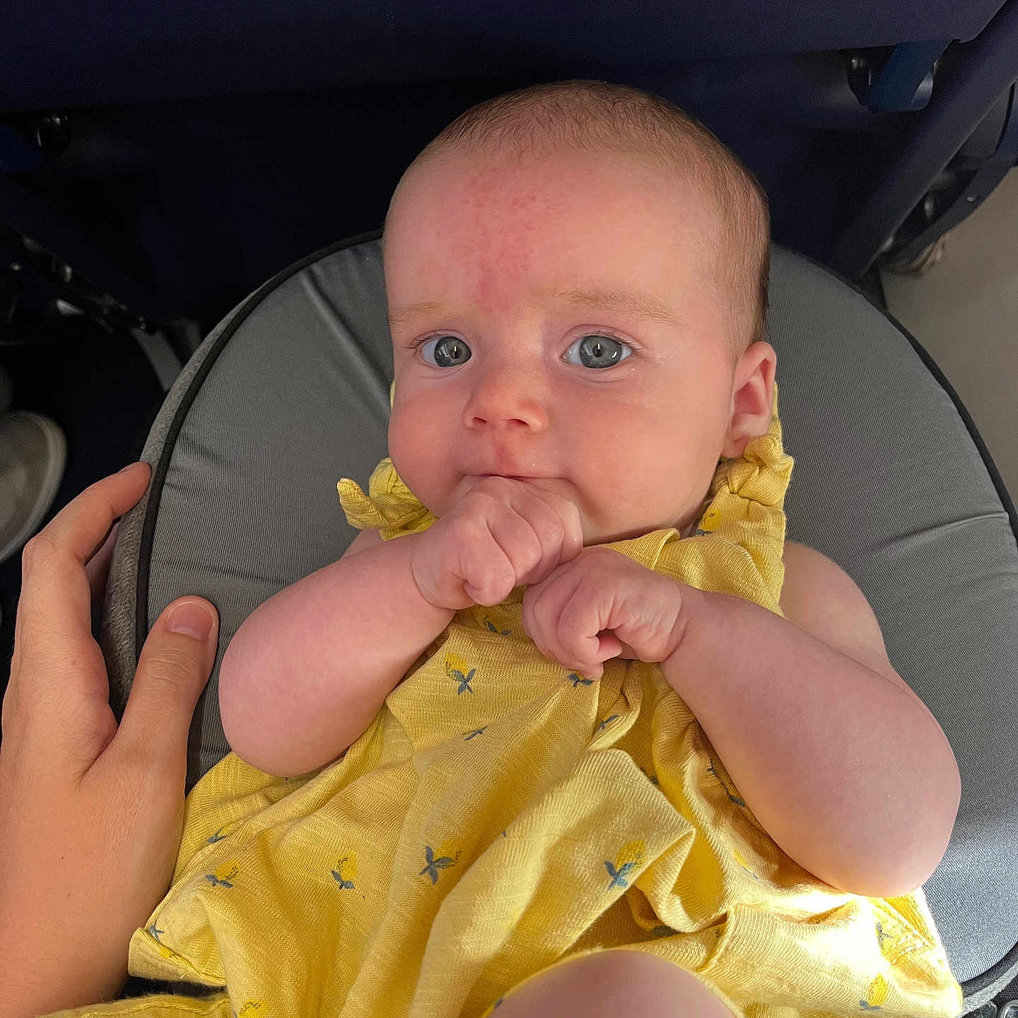 Bettie joined the competition — help win amazing prizes! apparel, baby, casual, child, closeup, comfort, cushion, cute, expression, face, fingers, hand, human, indoor, infant, person, sitting, skin, support, yellow_dress