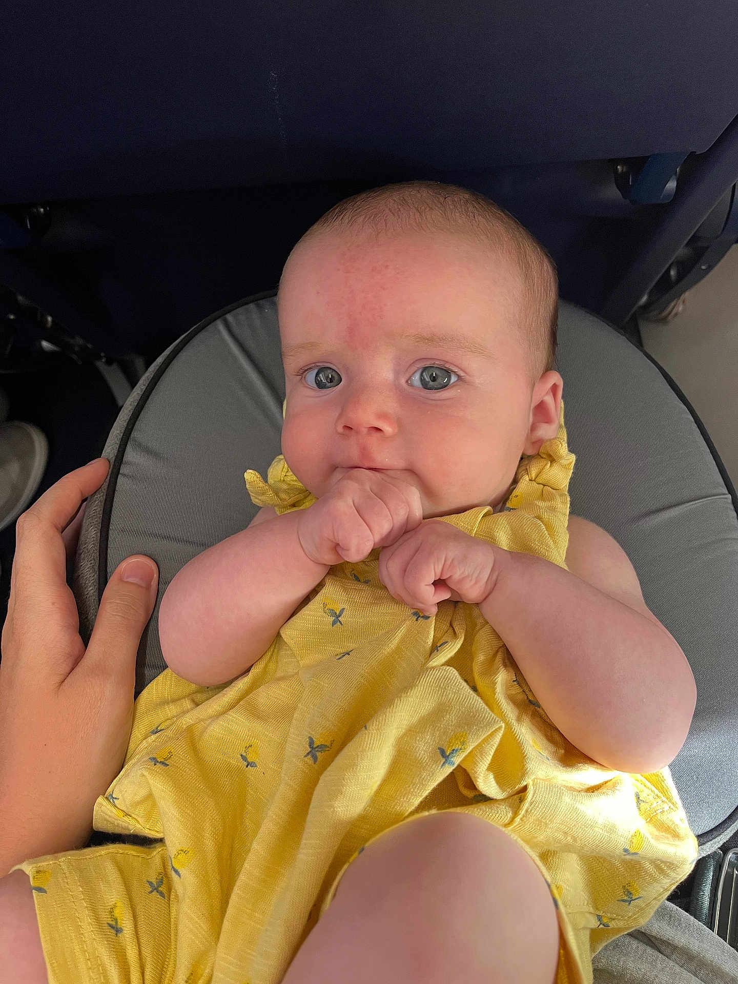 Bettie joined the competition — help win amazing prizes! baby, yellow_dress, hand, cushion, person, infant, face, skin, fingers, sitting, indoor, comfort, cute, child, closeup, apparel, human, expression, support, casual