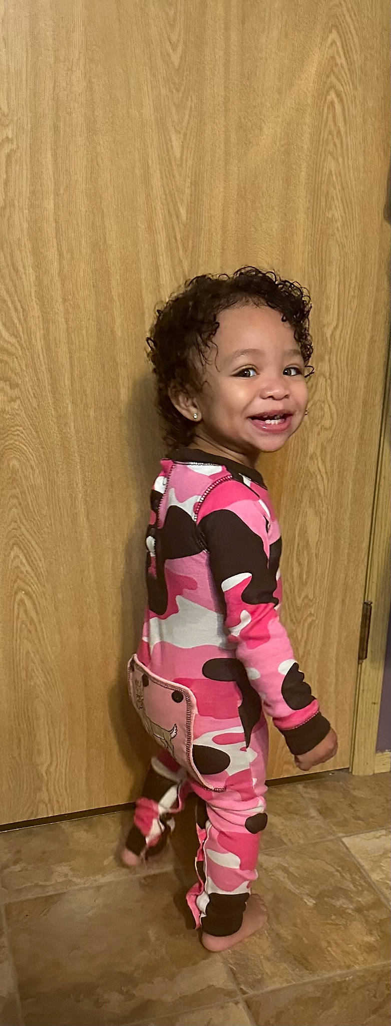 Kamiyah is registered to the contest to win money with this photo: arm, baby_toddler_clothing, cheek, dress, fashion_design, happy, human_body, joy, magenta, neck, pattern, person, pink, shoulder, skin, sleeve, smile, t_shirt, toddler, trunk