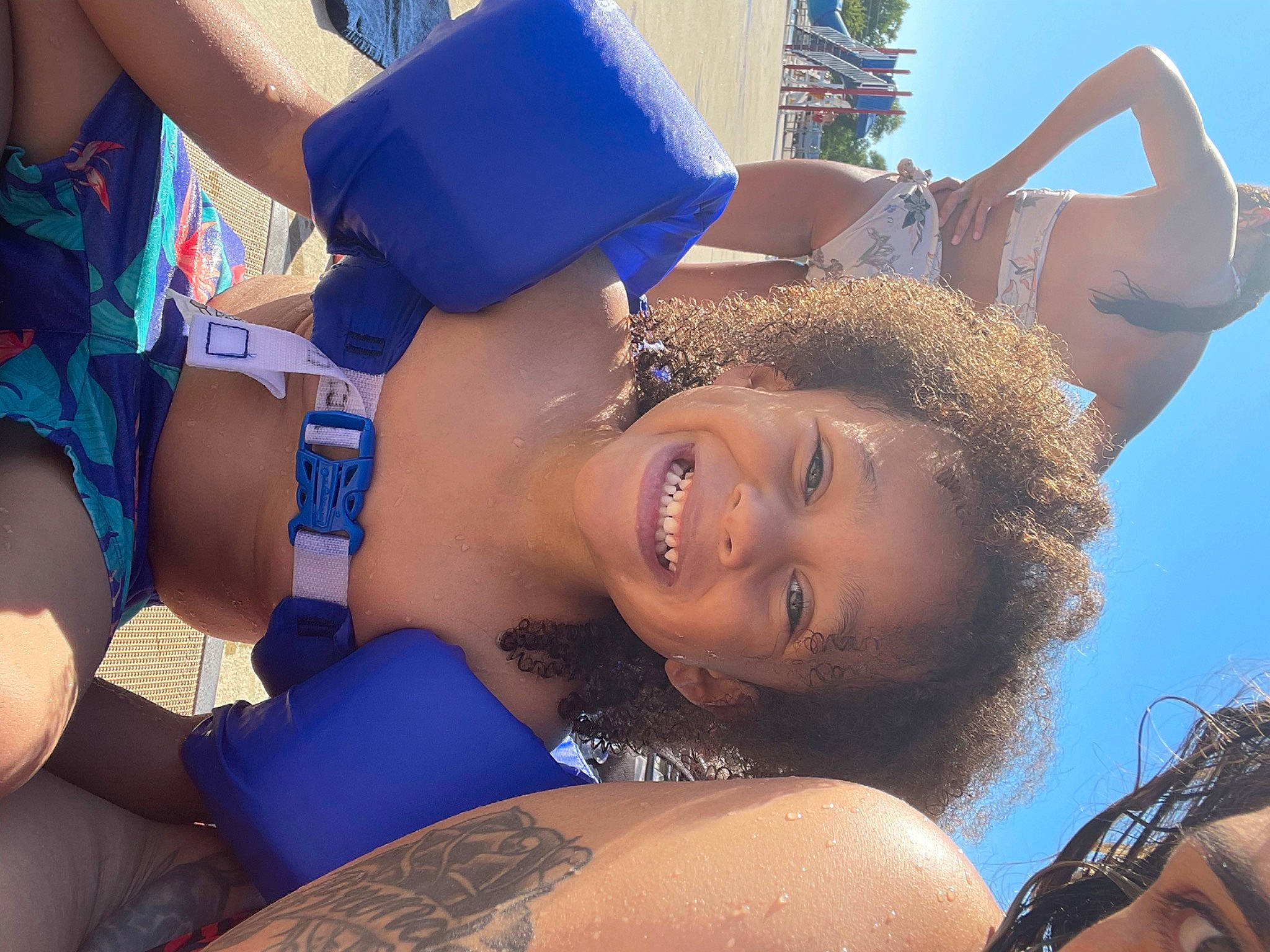 Jeremiah is registered to the contest to win money with this photo: black_hair, blue, cool, daytime, electric_blue, eyewear, facial_expression, friendship, fun, gesture, happy, interaction, joy, leisure, mouth, muscle, neck, person, shoulder, smile