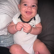 Jasiah joined the competition — help win amazing prizes! baby, smiling, sitting, infant, cute, happy, onesie, face, hands, feet, pillow, blanket, couch, indoor, child, person, skin, head, expression, closeup