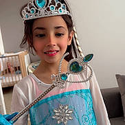 Djenna participe au concours pour gagner de l'argent avec cette photo : child, girl, princess, costume, tiara, wand, blue, white, dress, glitter, jewels, indoor, smiling, portrait, furniture, crib, couch, happy, person, play