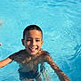 child, boy, swimming_pool, water, smiling, summer, outdoor, people, fun, happy, swimwear, sunlight, recreation, leisure, young, splashing, group, skin, arms, head